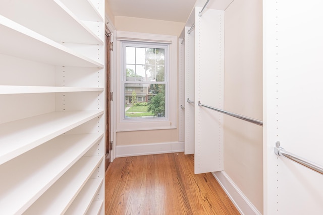 walk in closet featuring light hardwood / wood-style flooring