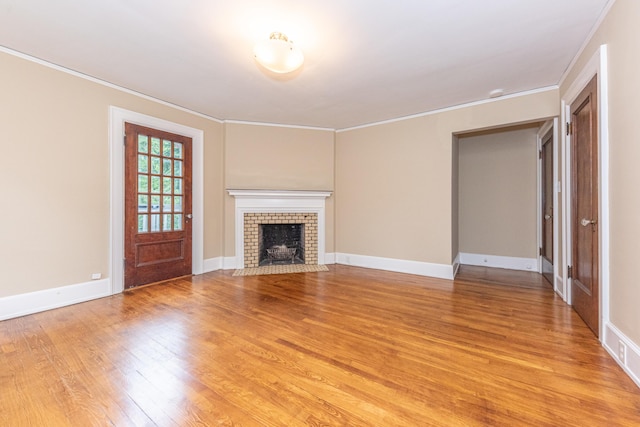 unfurnished living room featuring light hardwood / wood-style flooring and crown molding