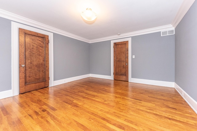 interior space featuring light hardwood / wood-style floors and crown molding