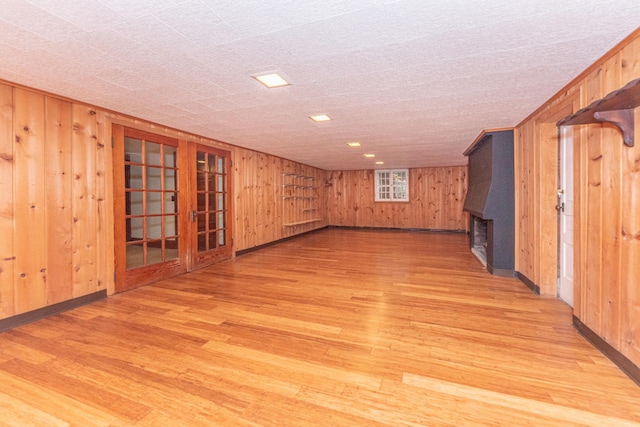 basement with wood walls and wood-type flooring