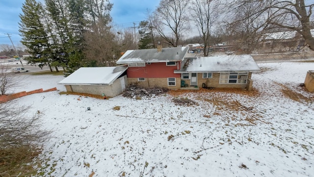 view of snow covered rear of property