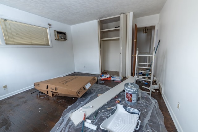 bedroom featuring a textured ceiling, a closet, and dark wood-type flooring