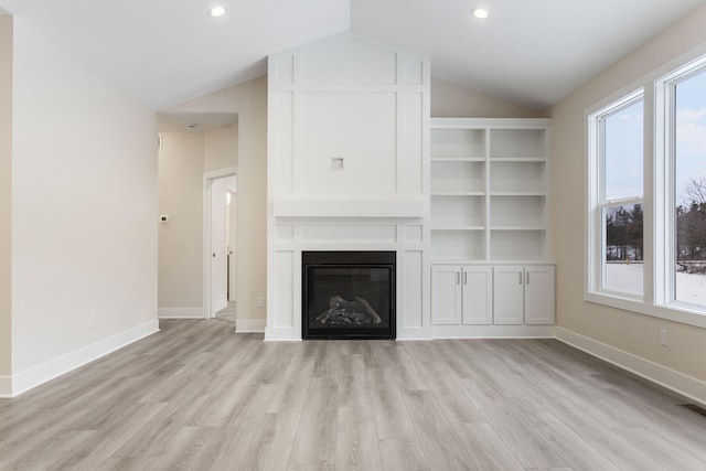 unfurnished living room with light hardwood / wood-style flooring and lofted ceiling