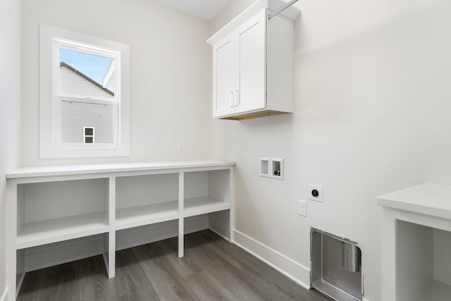 washroom with electric dryer hookup, dark hardwood / wood-style flooring, hookup for a washing machine, and cabinets