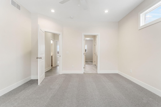 carpeted empty room featuring ceiling fan