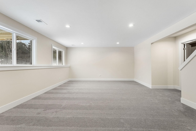 unfurnished room featuring light colored carpet