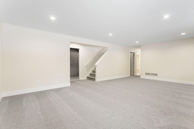 basement featuring light colored carpet