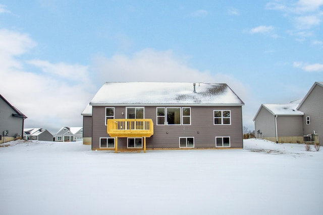 snow covered property with central air condition unit