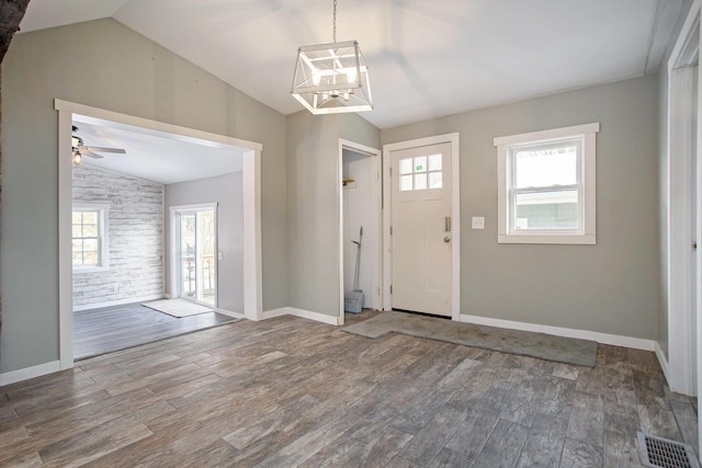 foyer entrance featuring ceiling fan, wood-type flooring, and lofted ceiling