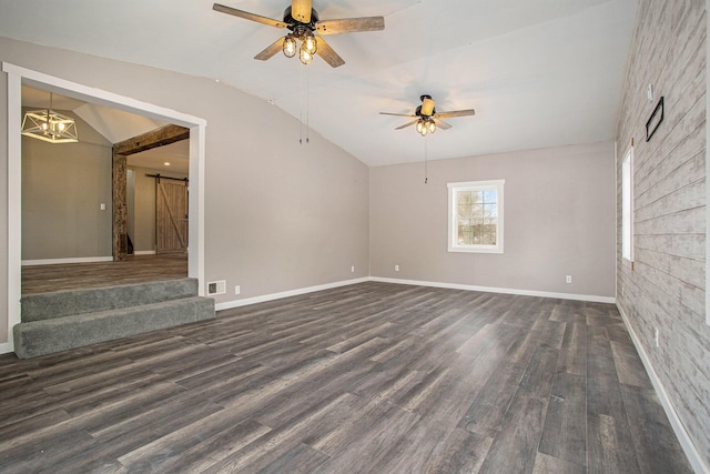 unfurnished living room featuring ceiling fan with notable chandelier, a barn door, dark wood-type flooring, and lofted ceiling