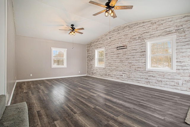 empty room with ceiling fan, dark hardwood / wood-style floors, and lofted ceiling