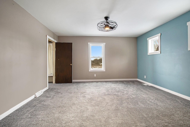 unfurnished room featuring carpet