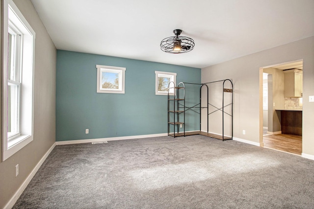 unfurnished bedroom with carpet and multiple windows