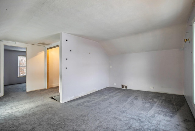 bonus room featuring carpet flooring, a textured ceiling, and vaulted ceiling