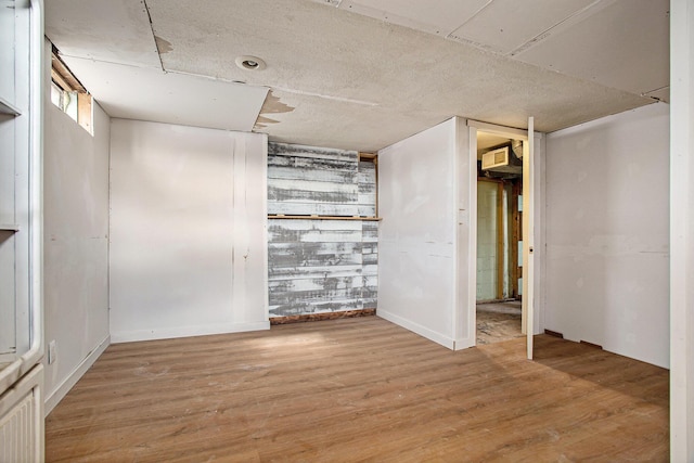 empty room with light hardwood / wood-style flooring