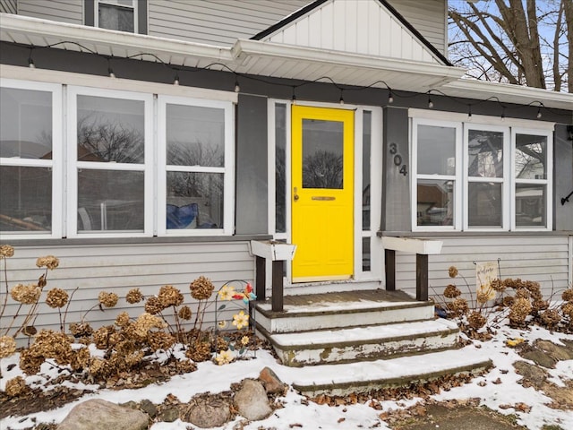 view of snow covered property entrance