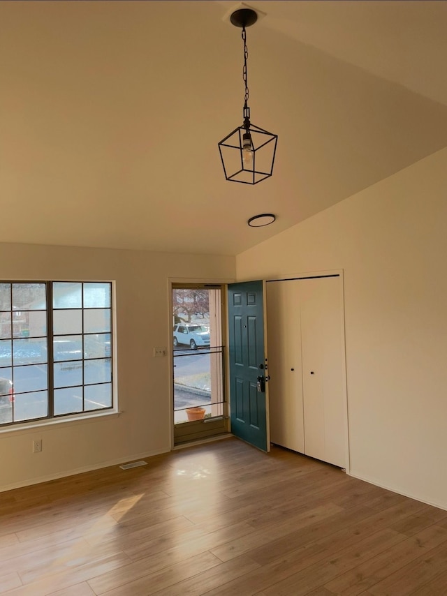 entrance foyer featuring lofted ceiling and hardwood / wood-style floors