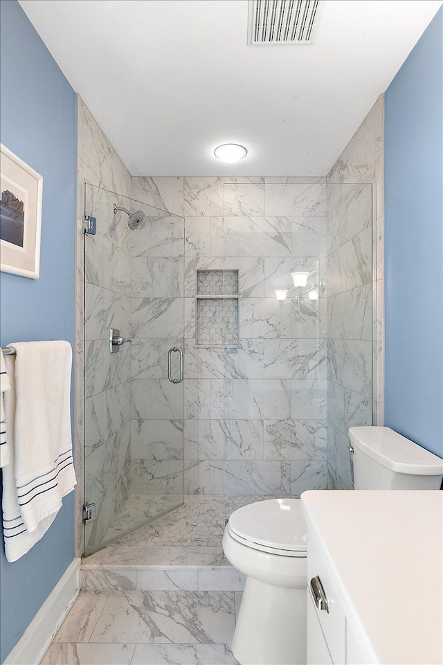 bathroom with a shower with door, vanity, and toilet