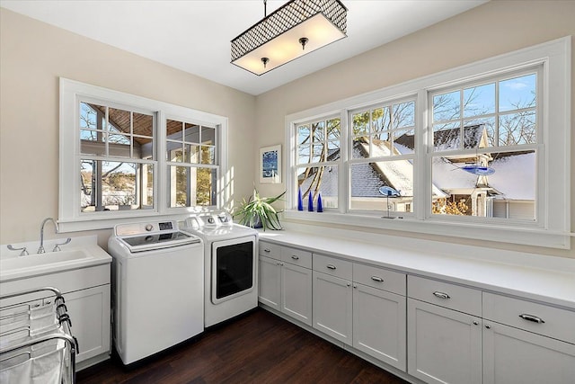 clothes washing area featuring cabinets, separate washer and dryer, plenty of natural light, and sink