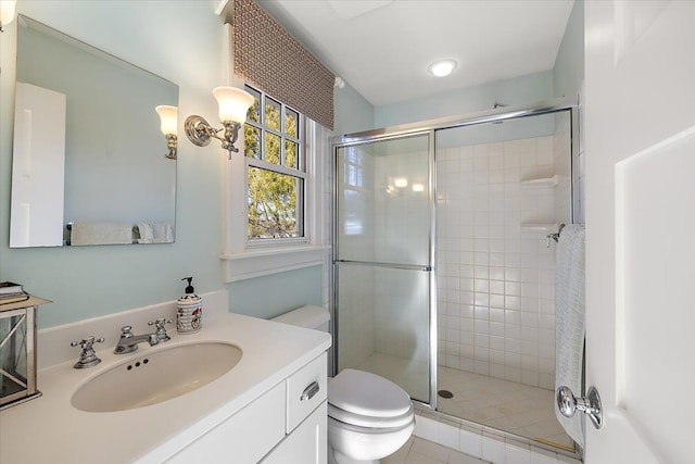 bathroom with vanity, a shower with shower door, and toilet