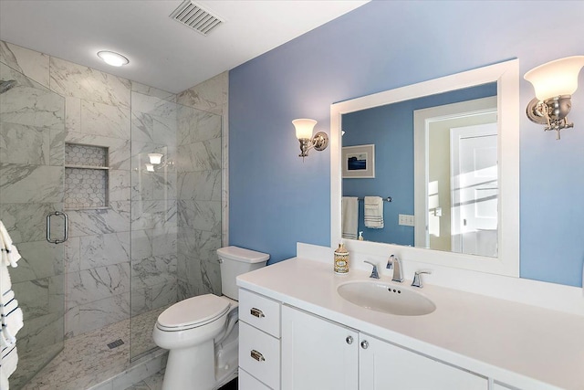 bathroom featuring vanity, toilet, and a shower with door