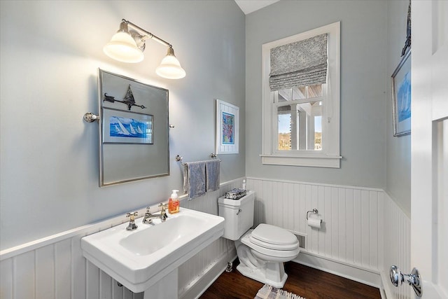 bathroom featuring toilet, wood-type flooring, and sink