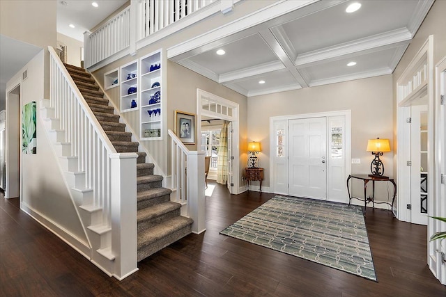 foyer entrance with beam ceiling, dark hardwood / wood-style floors, ornamental molding, and coffered ceiling