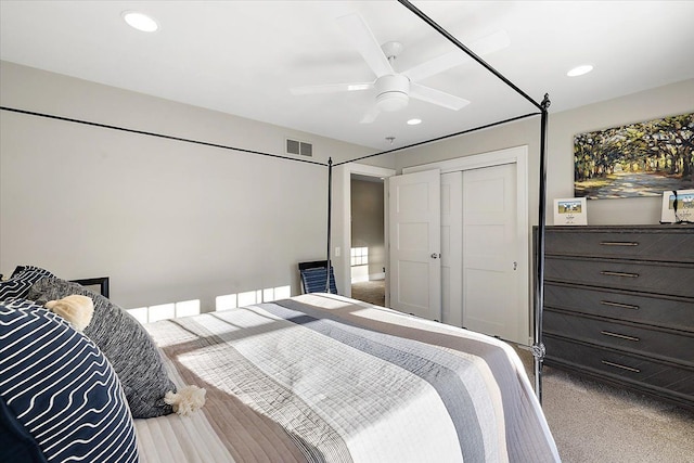 carpeted bedroom featuring ceiling fan and a closet