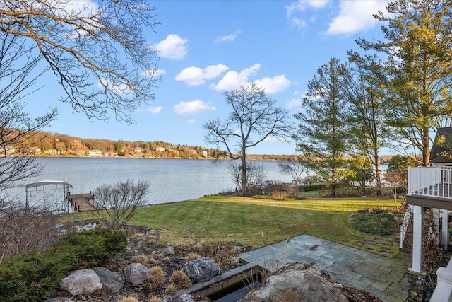 view of yard featuring a water view and a patio area