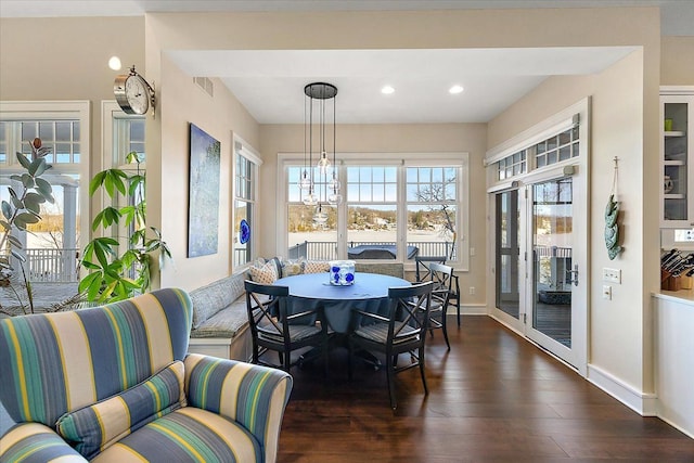 sunroom / solarium with a chandelier