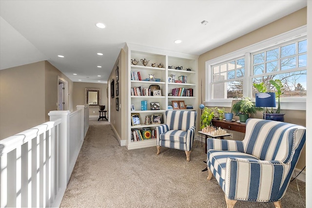 living area featuring light colored carpet and built in features