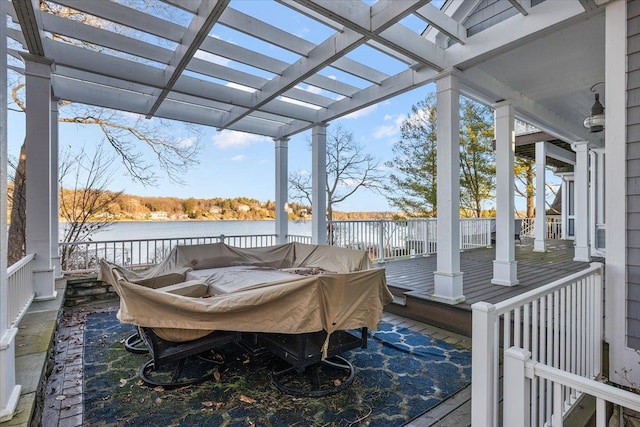 wooden deck featuring a water view and a pergola