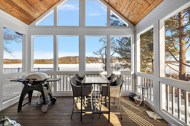 sunroom featuring a water view, lofted ceiling, and wood ceiling