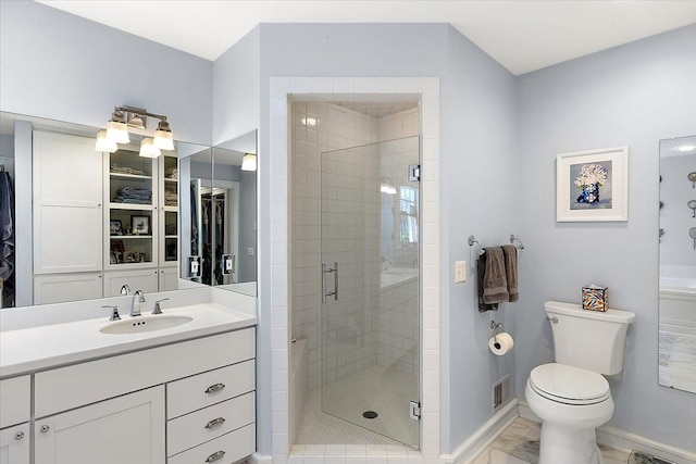 bathroom featuring toilet, vanity, and walk in shower