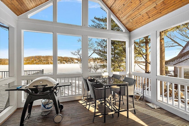 sunroom with a water view, vaulted ceiling, and wooden ceiling