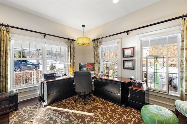 office area with plenty of natural light and dark wood-type flooring