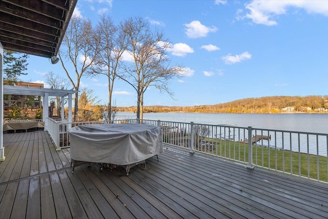 wooden deck featuring a water view