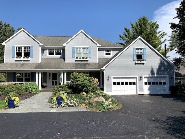 view of front facade featuring covered porch and a garage