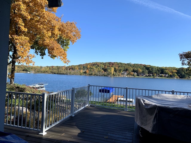 deck featuring a grill and a water view