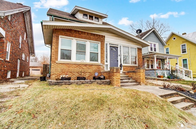 view of front facade with covered porch and a front yard