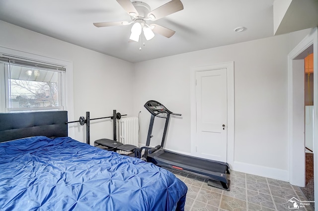 bedroom with ceiling fan and radiator heating unit