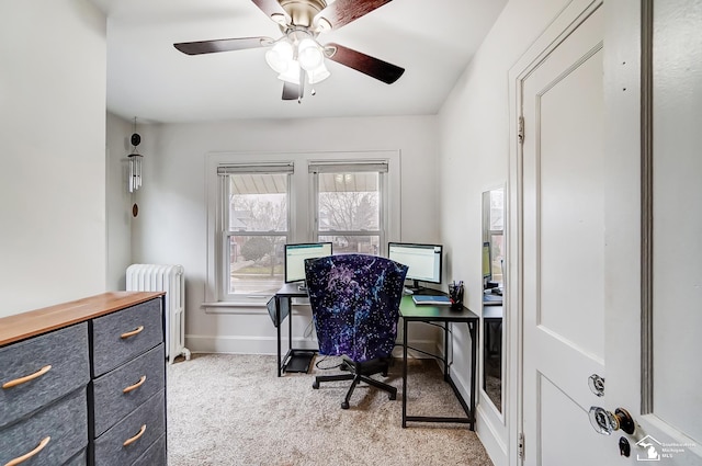 carpeted office featuring radiator heating unit and ceiling fan