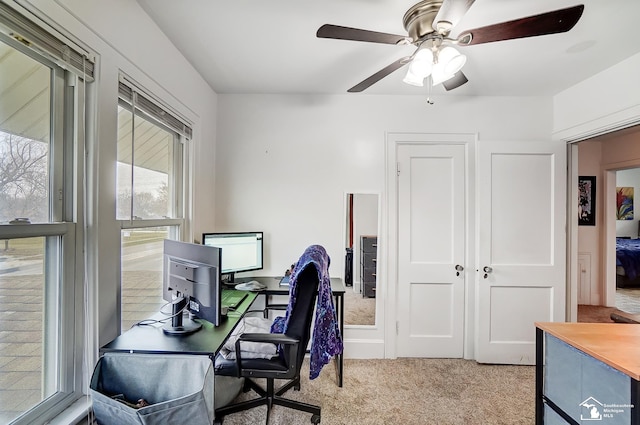 office space with ceiling fan and light colored carpet