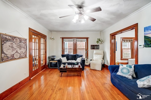 living room with ceiling fan, french doors, light hardwood / wood-style floors, and ornamental molding