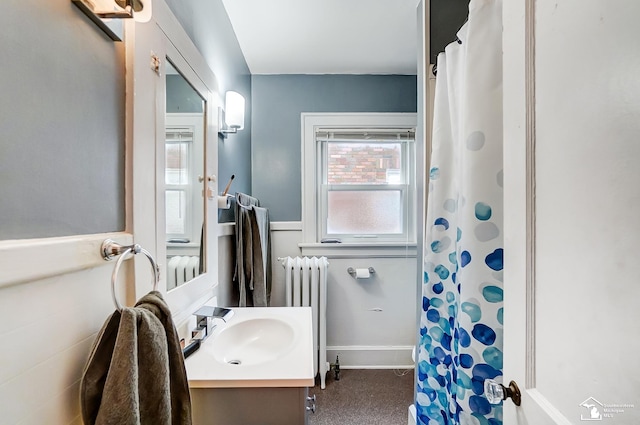 bathroom with a shower with curtain, vanity, and radiator