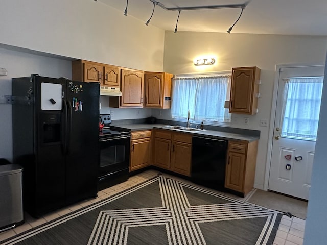 kitchen featuring exhaust hood, sink, vaulted ceiling, and black appliances