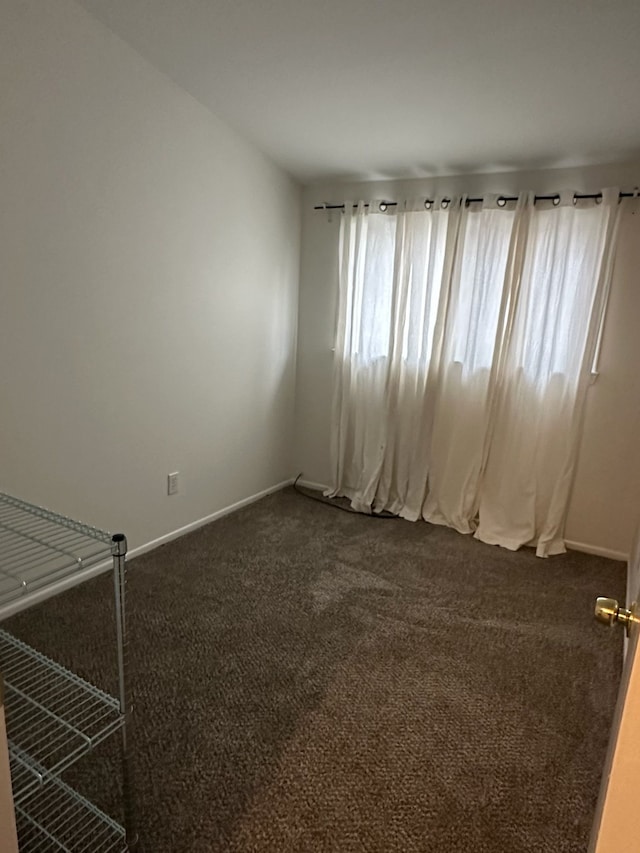 empty room featuring dark carpet