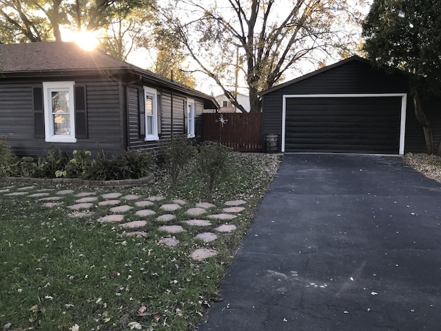 view of side of property featuring an outbuilding and a garage