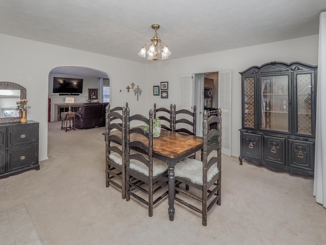 carpeted dining room featuring a chandelier