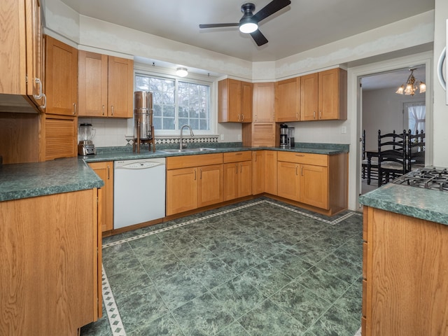 kitchen featuring white dishwasher, ceiling fan with notable chandelier, backsplash, and sink